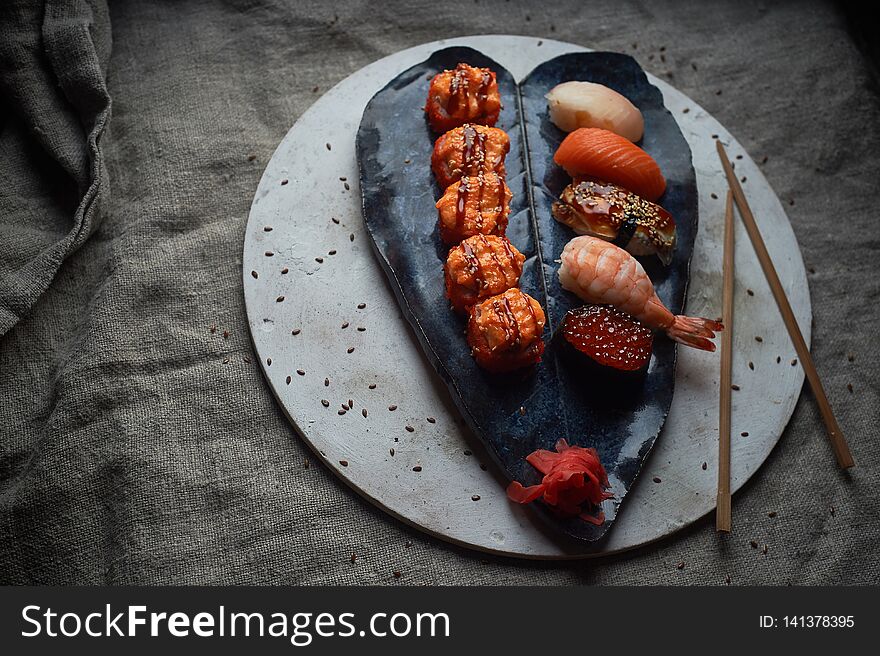 Japanese cuisine on handmade ceramics. Sushi and roll