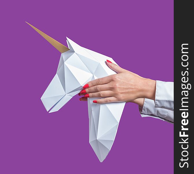 Hands Hold A White 3d Papercraft Model Of Unicorn. Minimal Art Concept