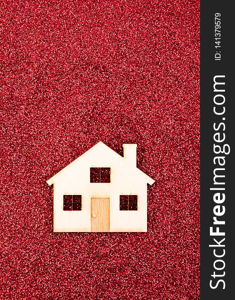 Small house shape on red glitter background