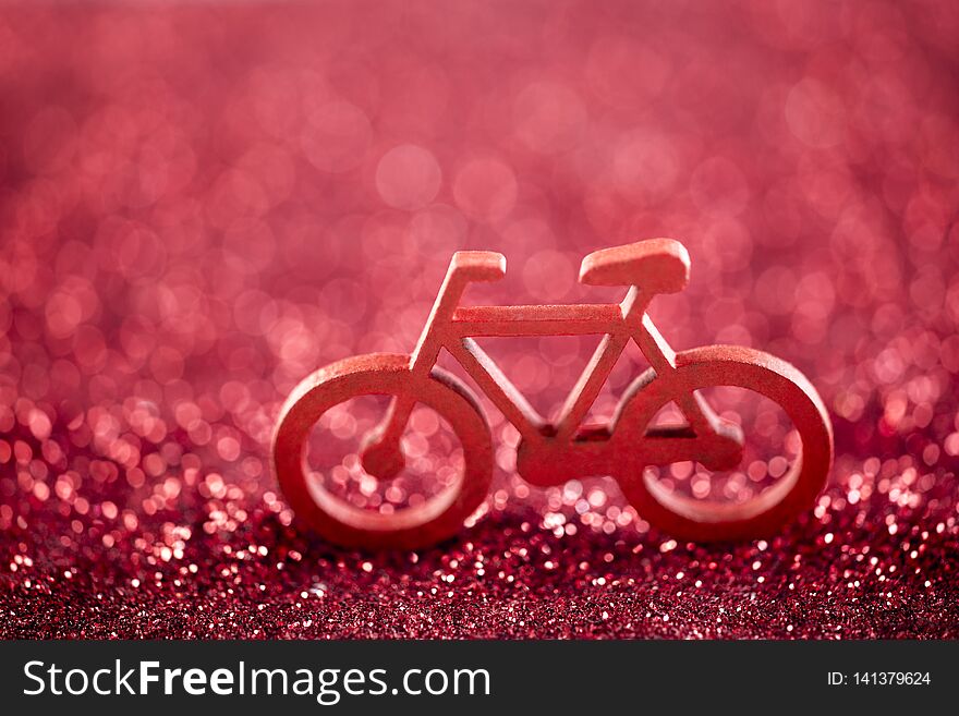 Bicycle shape on red glitter background