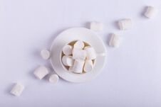 Empty Ceramic Cup With Marshmallows On A Saucer, On A White Background. Hard Shadow From The Sun, The Concept Of Morning Stock Images