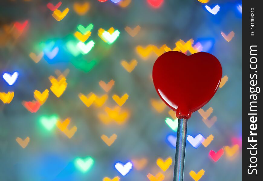 Red heart shaped toy On many background bokeh hearts.