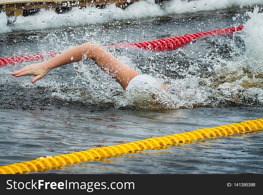 Lovers of winter swimming.Swimmer swims in the pool.He swims the distance at speed