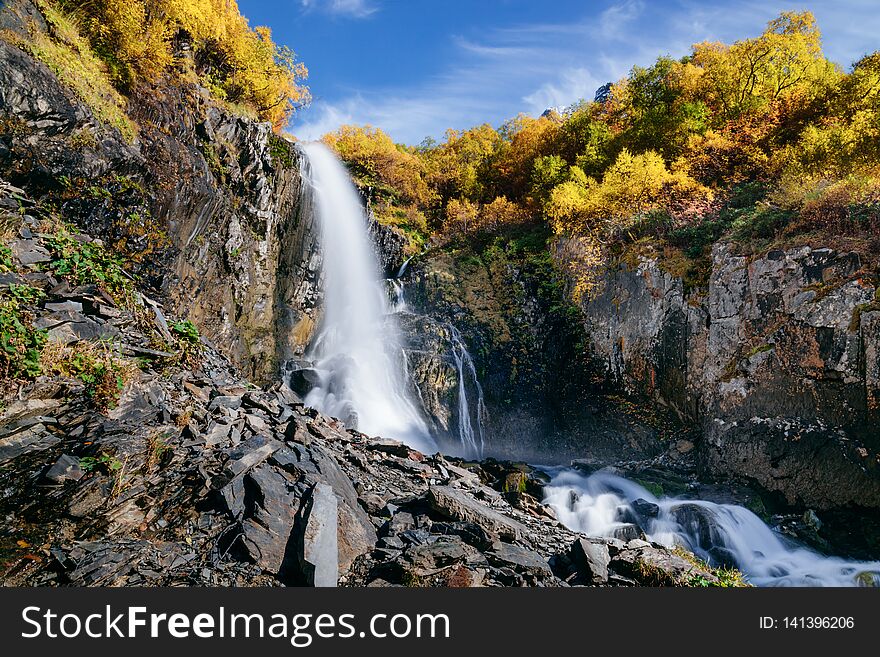 Waterfall in the mountains in the fall