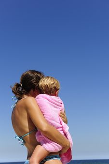Mother Carrying Her Daughter On The Beach Stock Photography Mother Carrying Her Daughter On The Beach Stock Photography