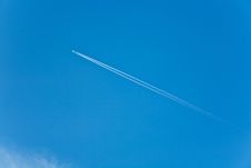 Blue Sky With Condension Trail Of An Aircraft Stock Photo