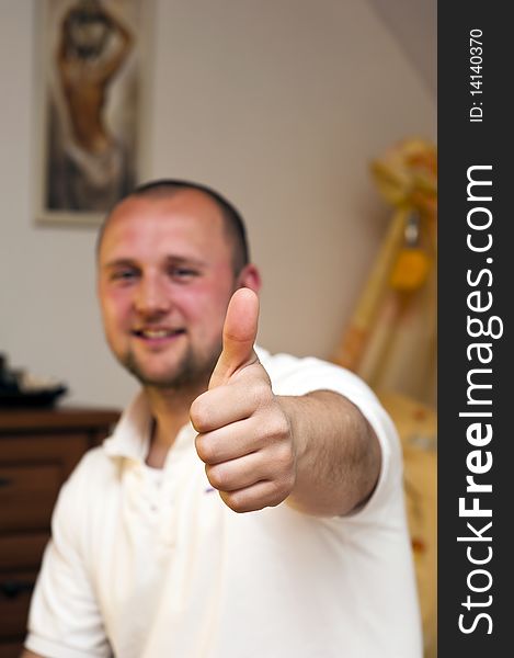 Man with thumbs up,selective focus on the thumb