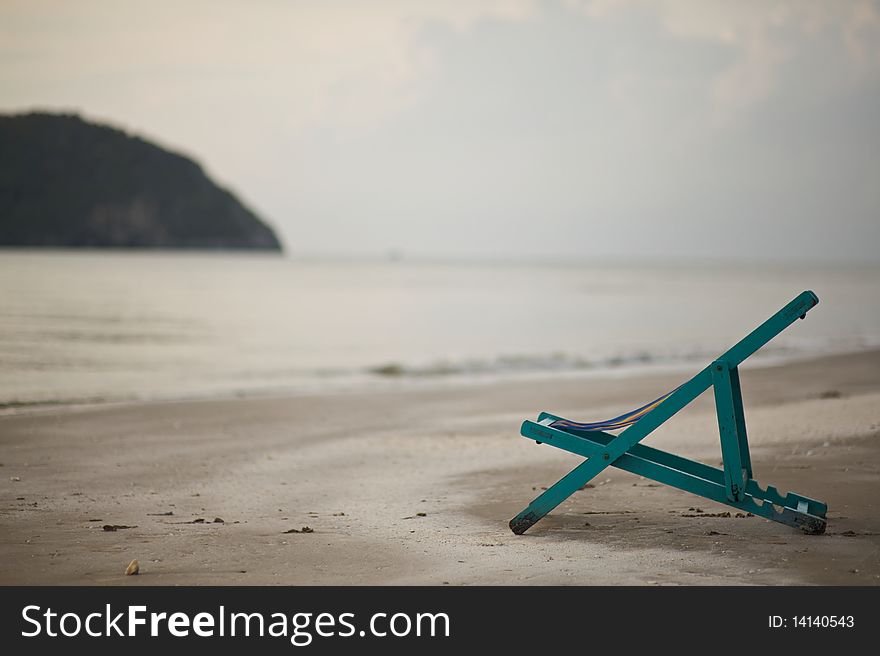 The empty chair by the beach giving the feeling of relaxation. The empty chair by the beach giving the feeling of relaxation.