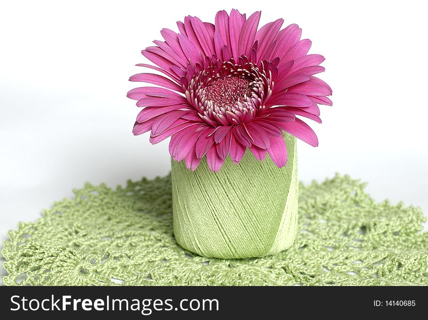 Pink flower in green roll on the hand made napkin