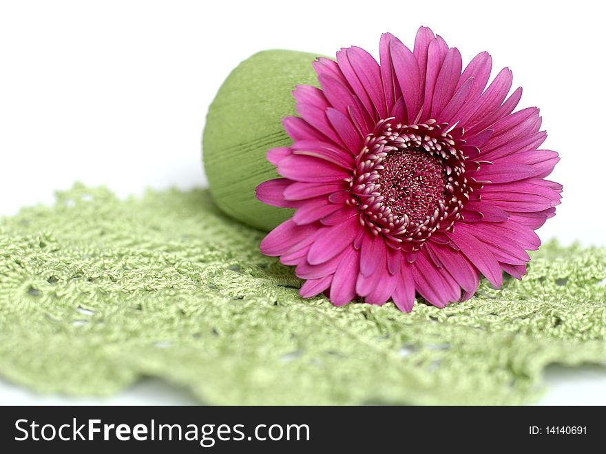 Pink flower in green roll on the hand made napkin