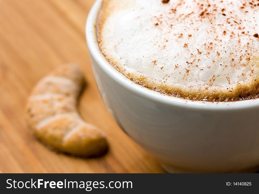 Cappuccino and Sweet Cookies on the wooden Background .