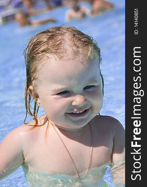 Sweet little girl in a swimming pool