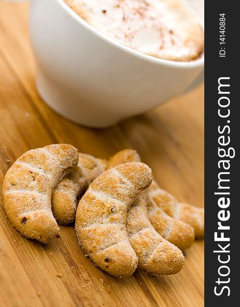 Cappuccino and Sweet Cookies on the wooden Backgro