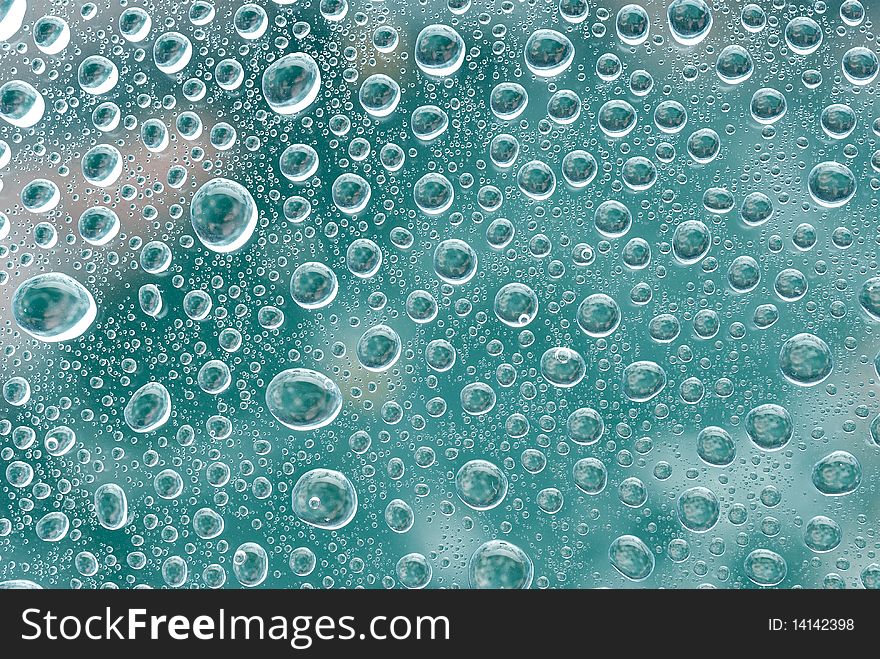 Water bubbles on a green glass. Abstract background
