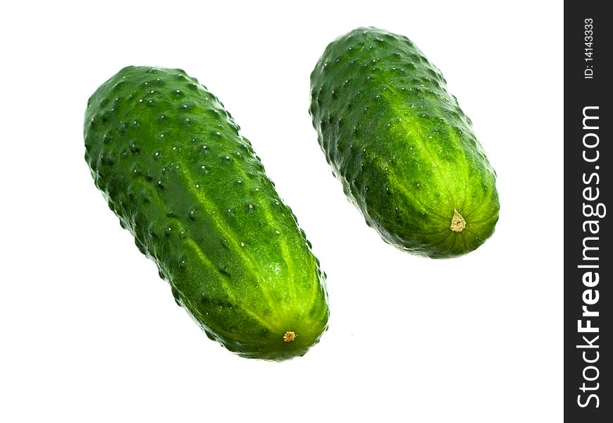 Two fresh green cucumbers friend near friend on white background. Two fresh green cucumbers friend near friend on white background