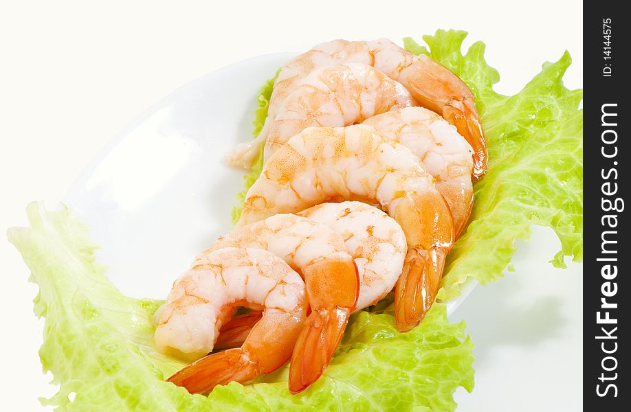 King prawns on a white plate isolated studio shot
