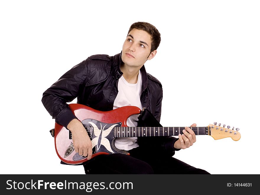 Young male guitarist playing on a red guitar. Young male guitarist playing on a red guitar