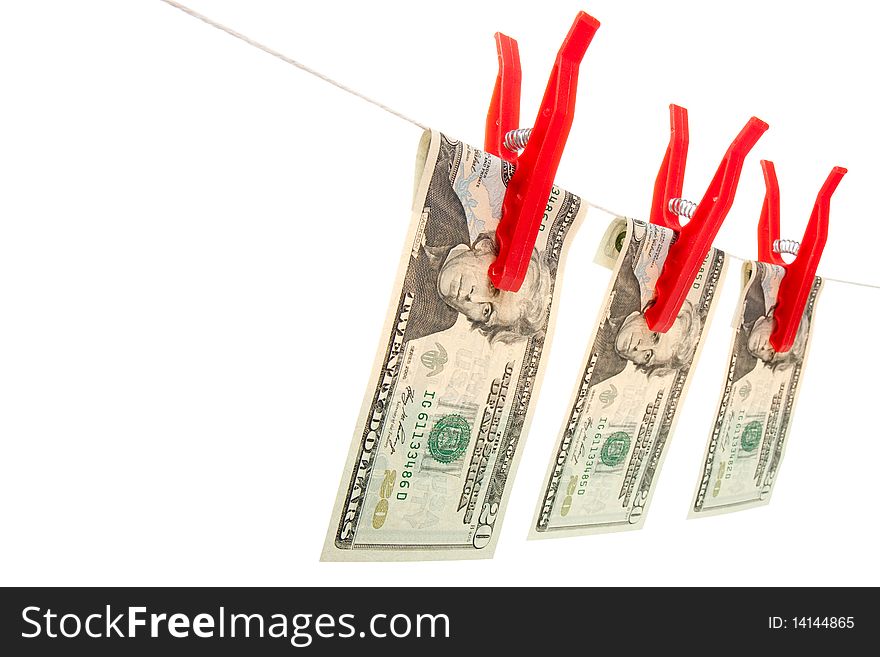 A line of three twenty dollar bills on a line as if they are drying. The bills are attached to the line with red clothes pegs. Studio isolated with an accurate clipping path. A line of three twenty dollar bills on a line as if they are drying. The bills are attached to the line with red clothes pegs. Studio isolated with an accurate clipping path.