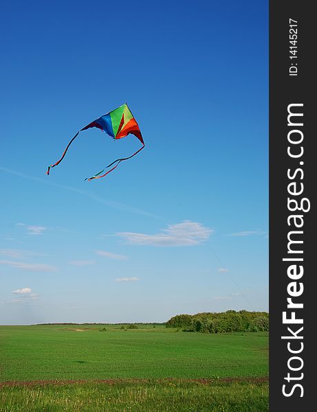 Bright multi-coloured kite flying in the sky