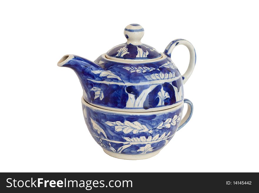 A blue nested ceramic teapot and cup. A blue nested ceramic teapot and cup