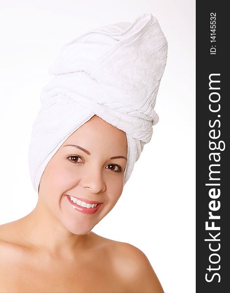 Young woman face with a towel in her head. Concept: freshness, shower and spa. Young woman face with a towel in her head. Concept: freshness, shower and spa