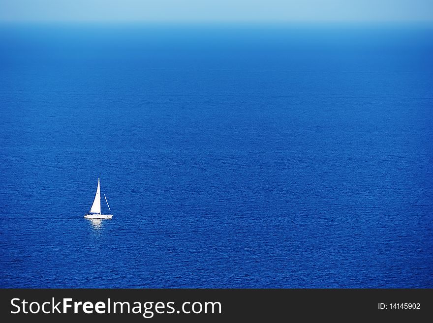 Tranquil seaside scene with one single sailboat. Germany. Tranquil seaside scene with one single sailboat. Germany.