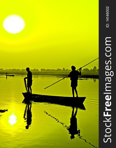 Silhouette: Fishermen on a boat