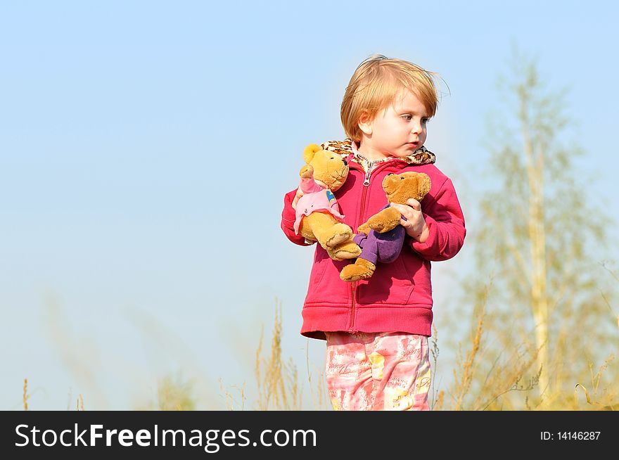 Kid girl with two toy bears in his hands