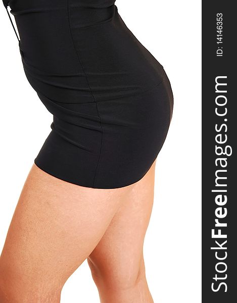 The nice round bottom of a young woman in a short tight black dress, with nice legs, standing in the studio for white background. The nice round bottom of a young woman in a short tight black dress, with nice legs, standing in the studio for white background.