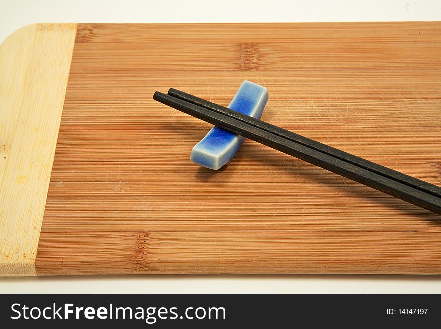 Close up of chopsticks on bamboo cutting board
