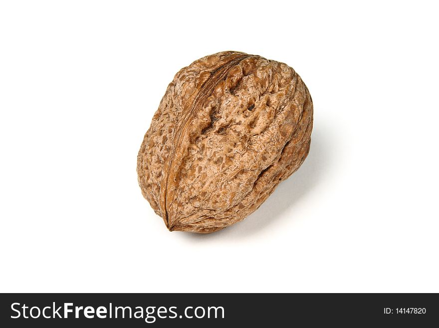 A raw walnut against white background