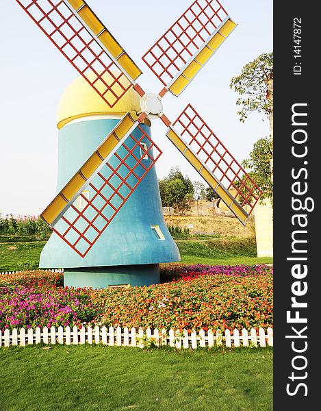 The windmill on garden ,colorful,grass ang Flower