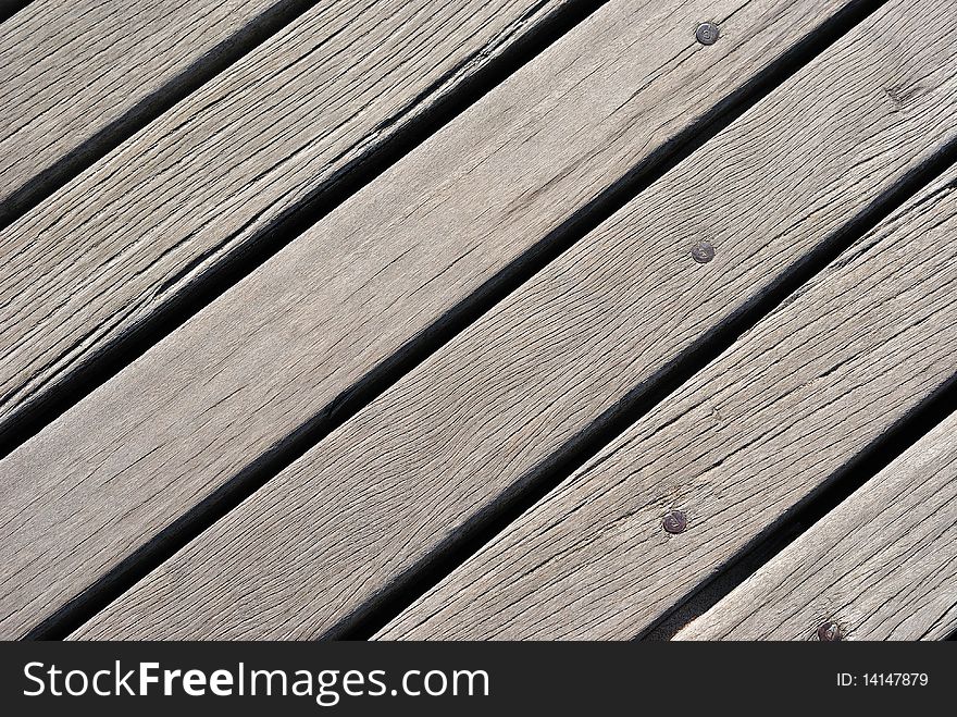 The close view of a boardwalk's wood grain. The close view of a boardwalk's wood grain.