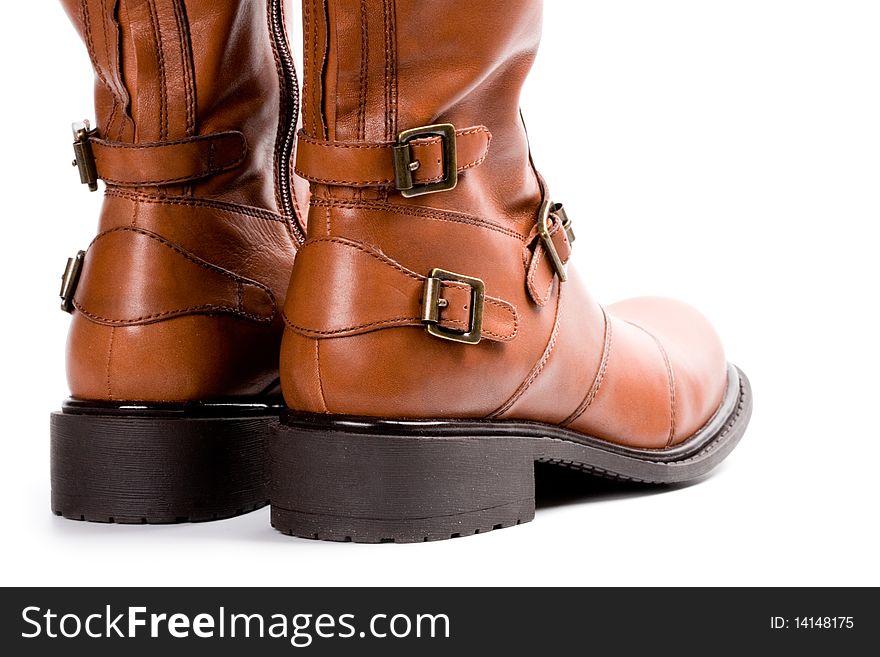 Pair of brown boots closeup on white background