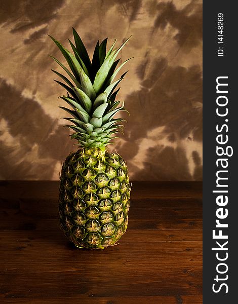 Photo of pineapple on wood table