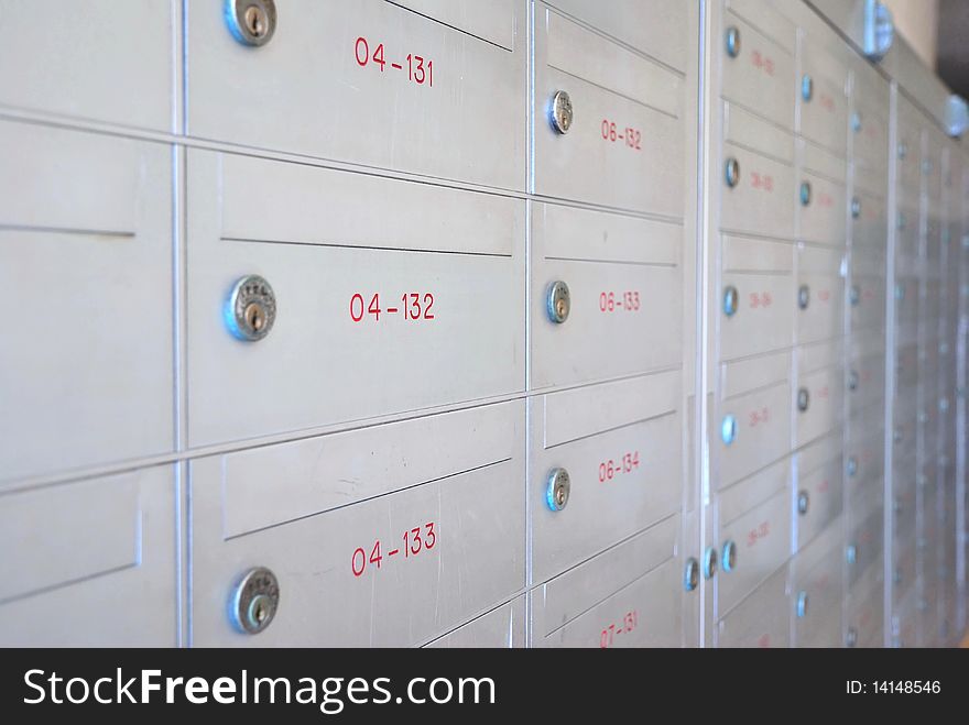 Row of metallic letter boxes with numbers and locks. For concepts such as safety and security, business communication and concepts. Row of metallic letter boxes with numbers and locks. For concepts such as safety and security, business communication and concepts.