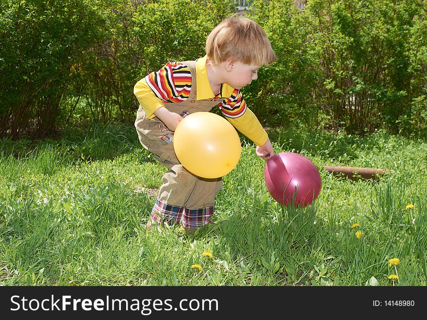 The little boy with balloons on walk. The little boy with balloons on walk