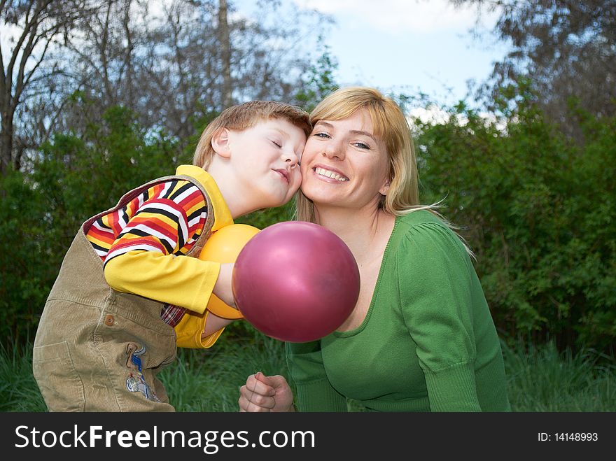 Mum with the son are played with balls in the spring on the nature. Mum with the son are played with balls in the spring on the nature