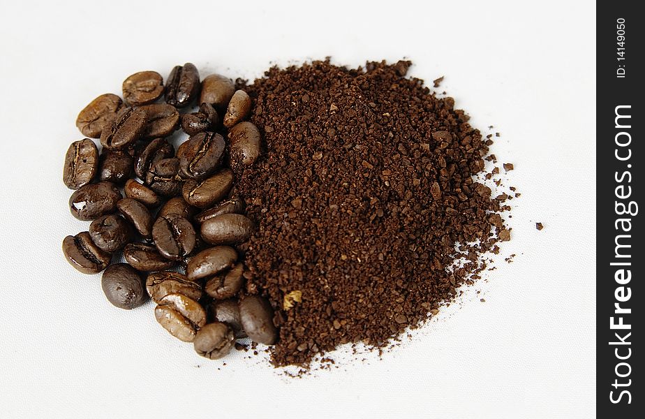 An arrangement of coffee beans and Powder on a white background