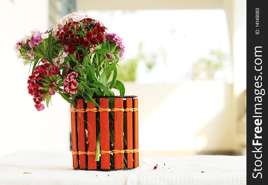 Red flower on wood basket