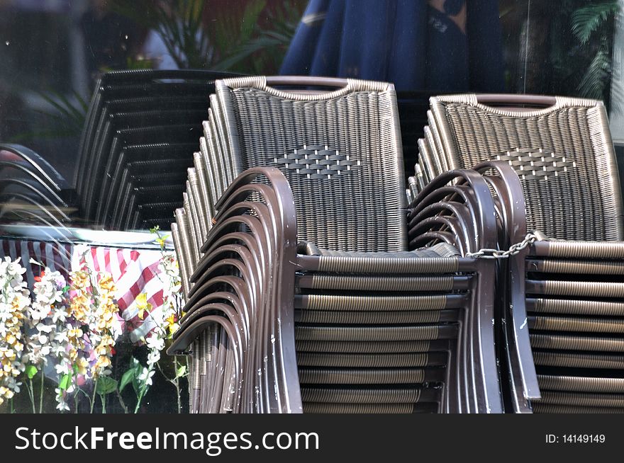 Folded chairs beside restaurant, with repeated design and shape comparing.