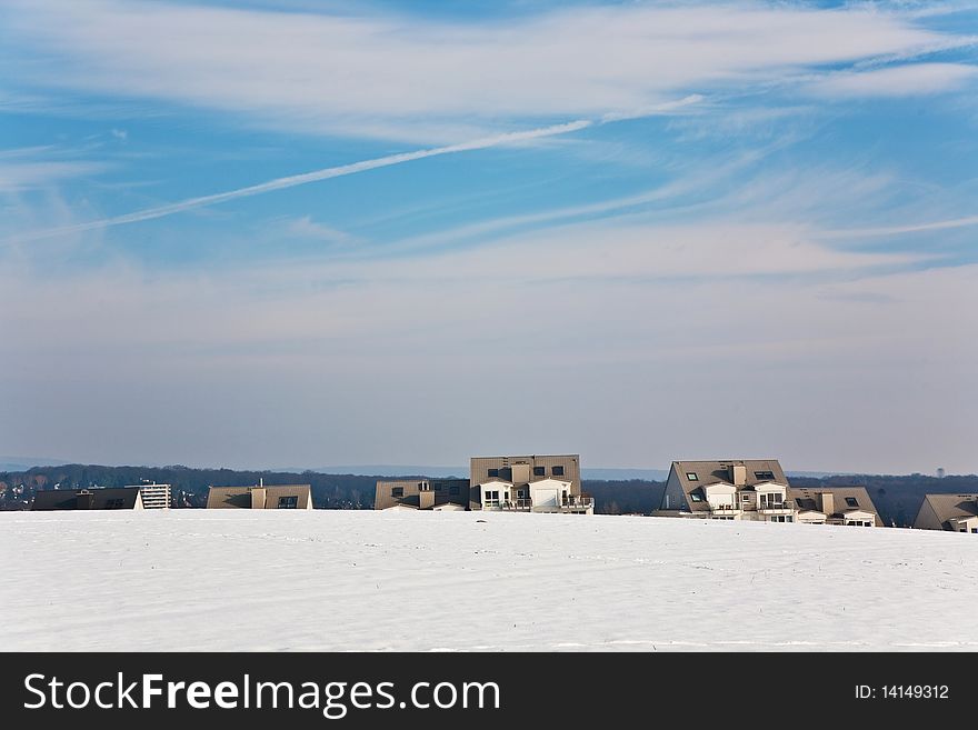 Landscape With Housing Area In Snow And Blue Sky