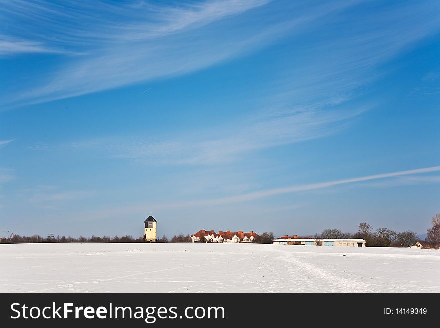 Beautiful landscape with water tower and housing area in winter and blue sky. Beautiful landscape with water tower and housing area in winter and blue sky