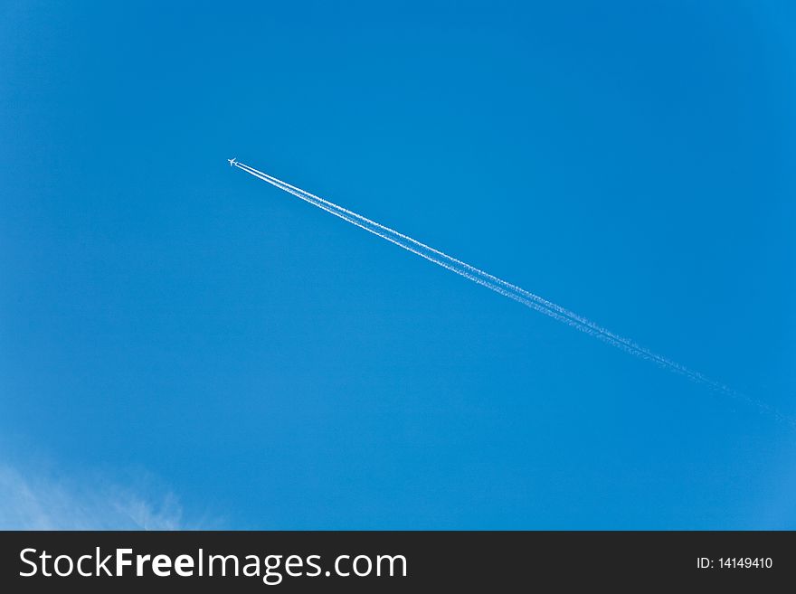 Blue Sky With Condension Trail Of An Aircraft