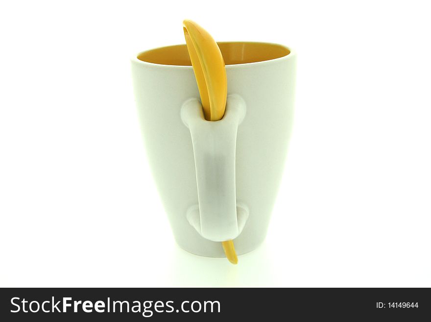 Simple, funny, useful white mug with yellow spoon. Simple, funny, useful white mug with yellow spoon.