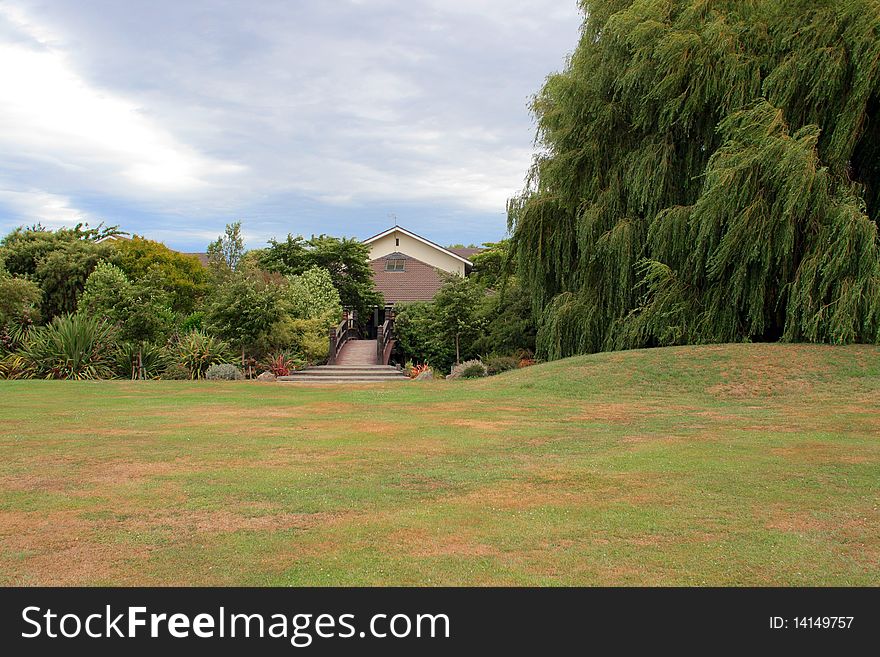 House And Foot Bridge Among Trees