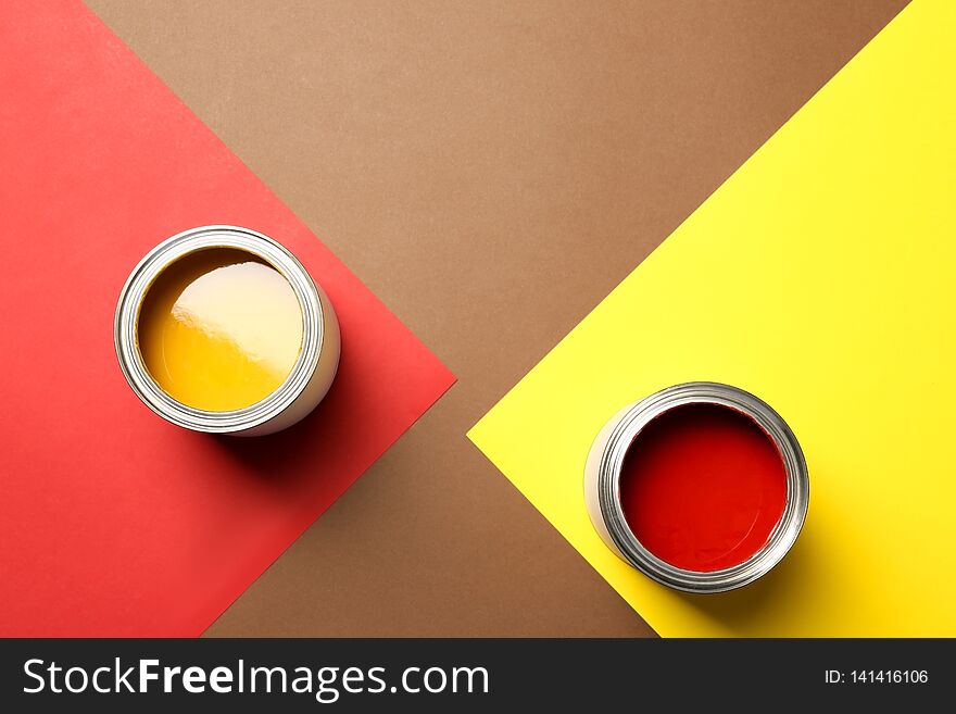 Flat lay composition with paint cans and space for text on color background