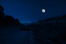 Mountain Road Through The Forest On A Full Moon Night. Scenic Night Landscape Of Dark Blue Sky With Moon. Azerbaijan Stock Photos