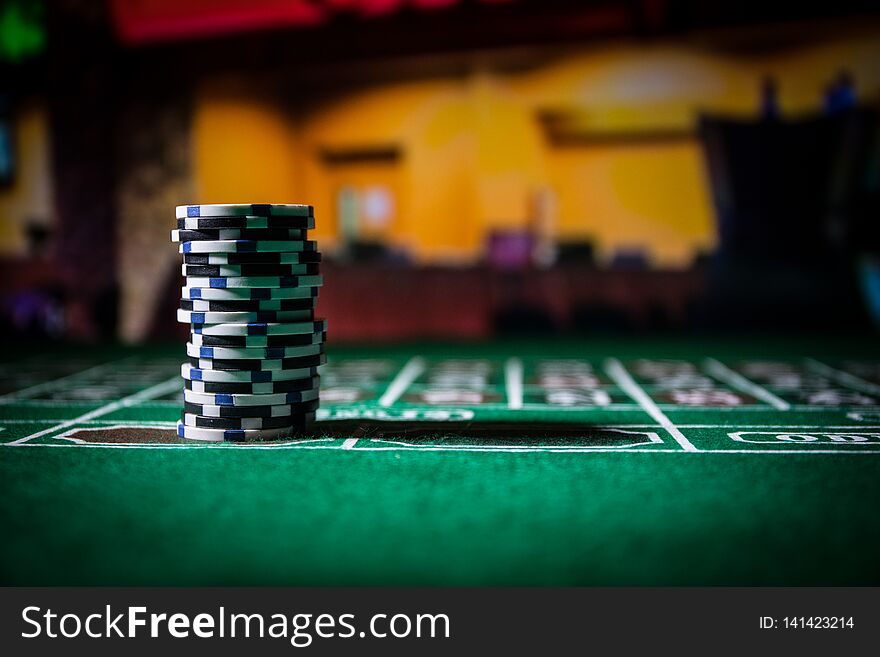 Cards and chips on green felt casino table. Abstract background with copy space. Gambling, poker, casino and cards games theme. Casino elements on green. Selective focus. Cards and chips on green felt casino table. Abstract background with copy space. Gambling, poker, casino and cards games theme. Casino elements on green. Selective focus