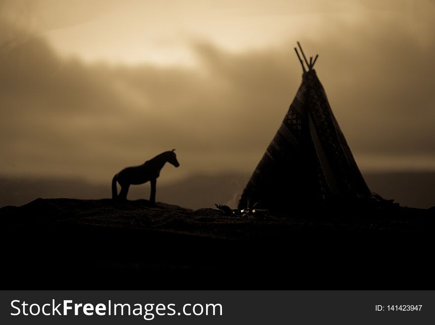 Artwork decoration creative concept. An old native american teepee in desert at the evening. Wigwam house indian style. Artwork decoration creative concept. An old native american teepee in desert at the evening. Wigwam house indian style